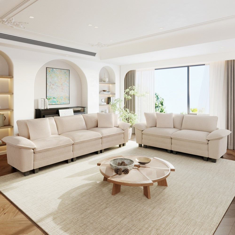 Modern living room with beige sectional sofas,and decorative elements.