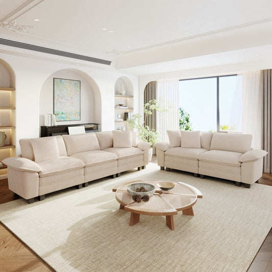 Modern living room with beige sectional sofas,and decorative elements.