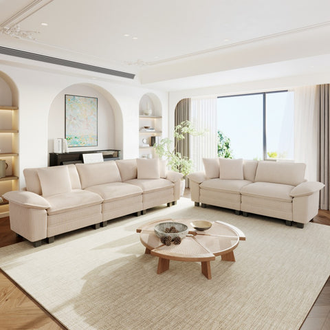 Modern living room with beige sectional sofas,and decorative elements.