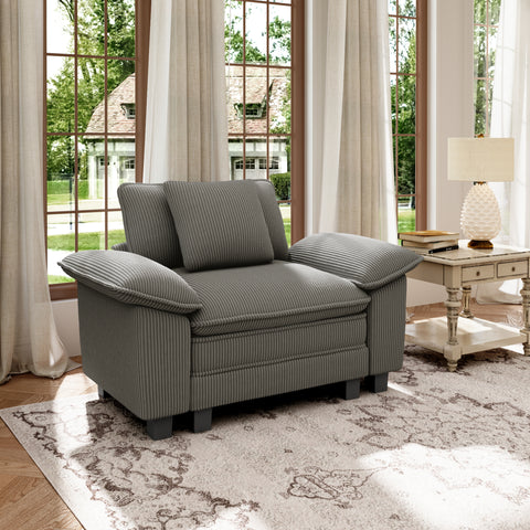 Gray corduroy sectional cloud couch in a living room with large windows and curtains.